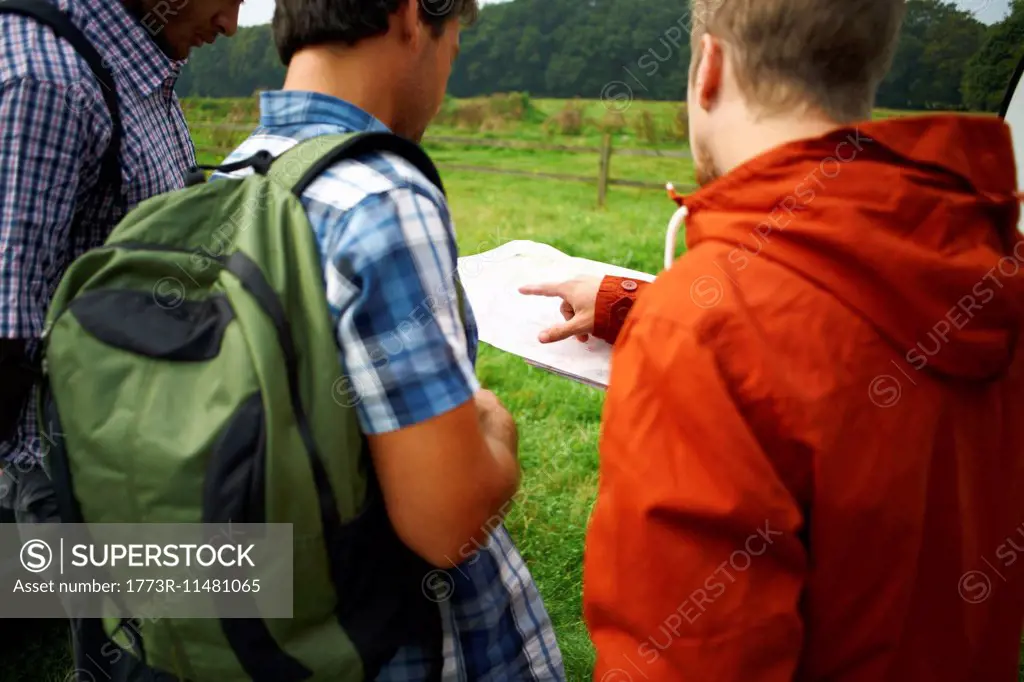 Three men looking at map