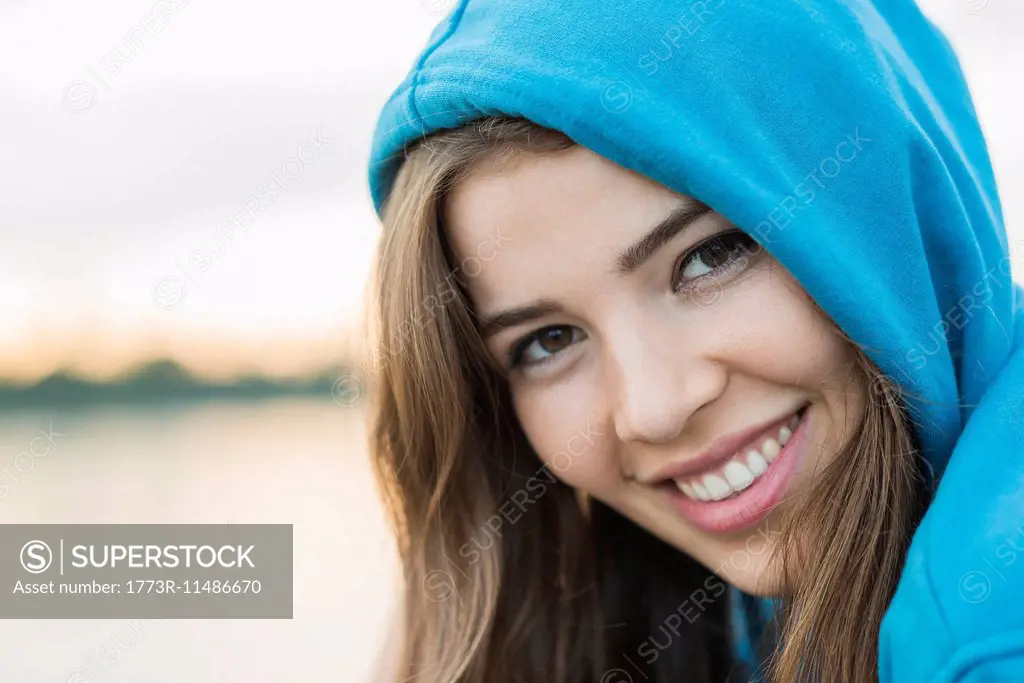Young woman wearing blue hooded top