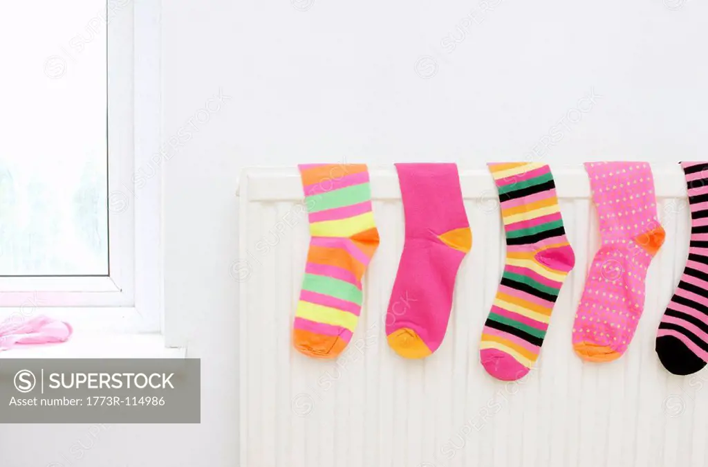 colored socks drying on radiator