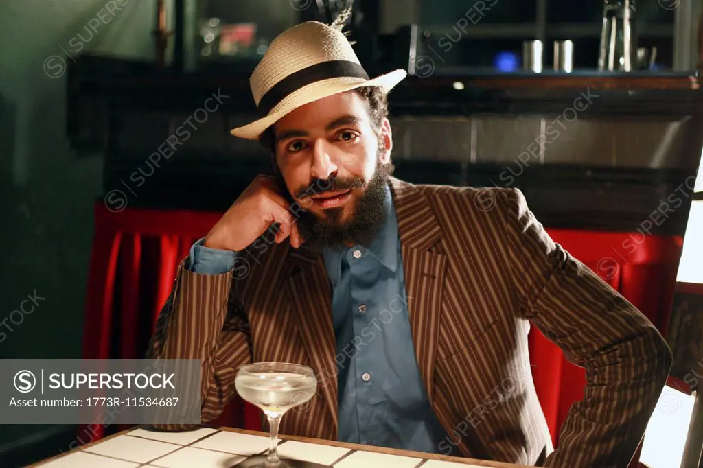 Man with cocktail at bar