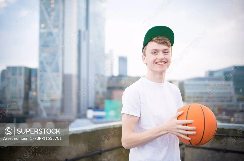 Teenage boy holding basketball