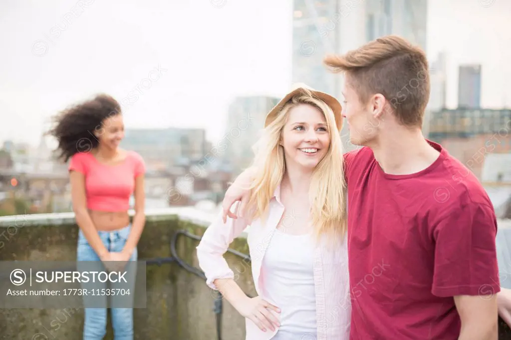 Young couple with arms around each other