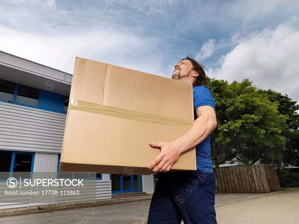 man carrying heavy box