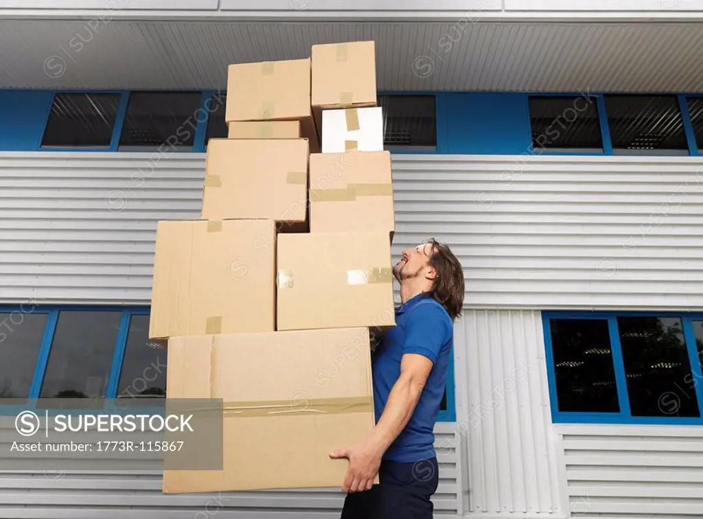 man carrying stack of boxes