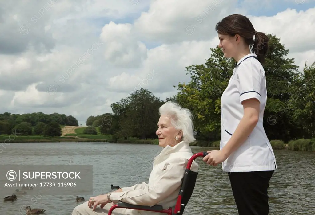 Elderly woman in wheelchair with nurse