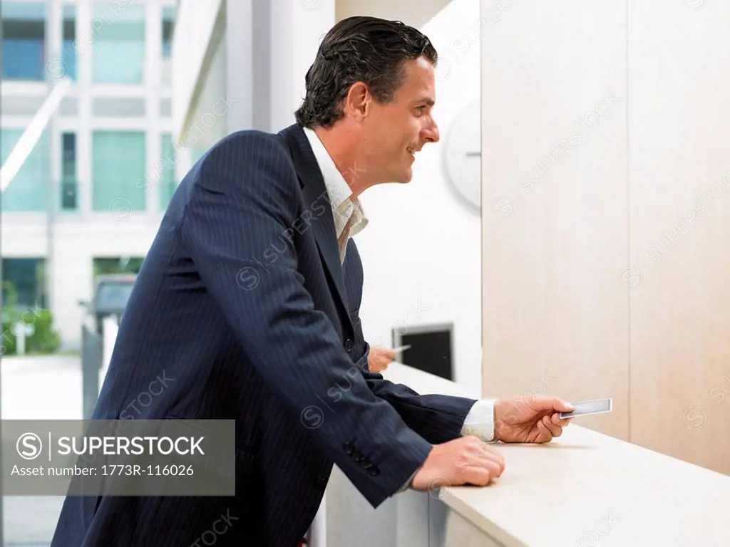Man with credit card at front desk