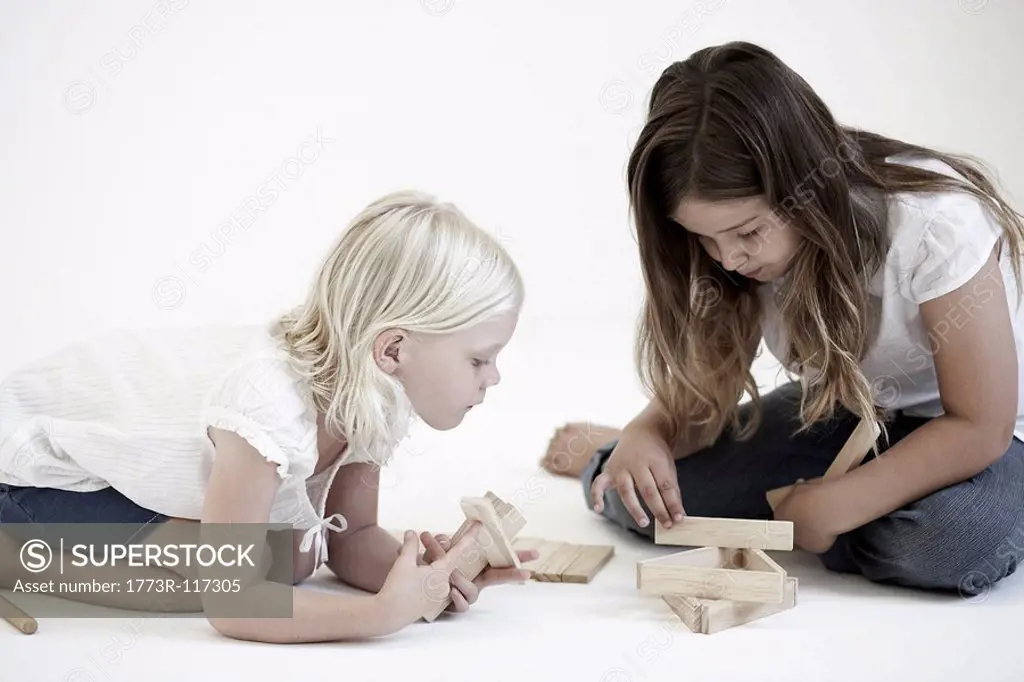 Young girls playing with building blocks