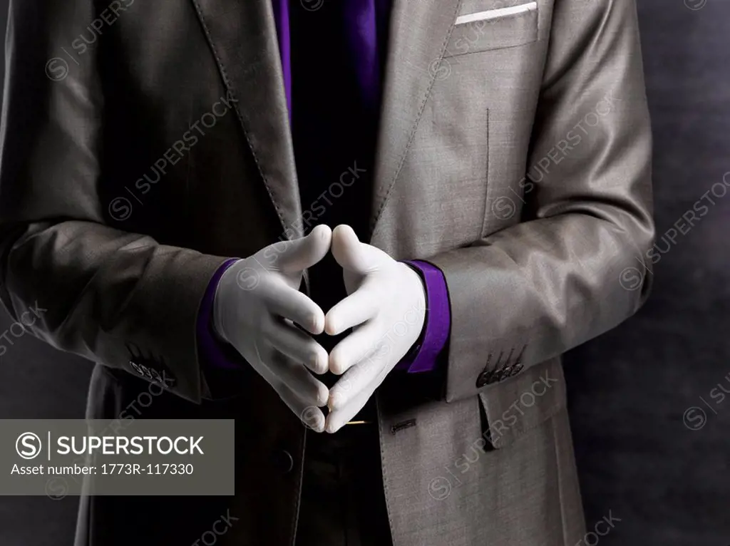 Business man wearing rubber gloves