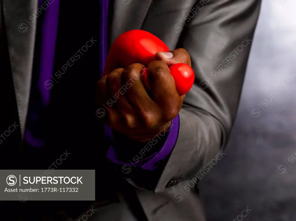 Business man squeezing stress ball