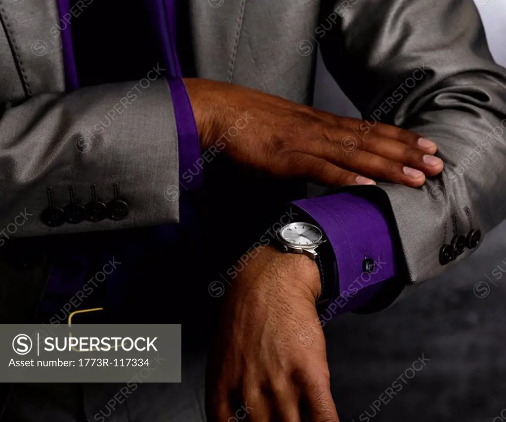 Business man looking at watch