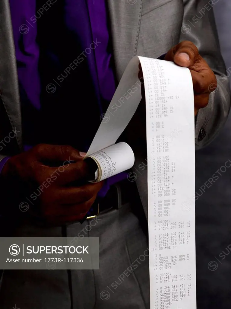 Business man with long paper receipt