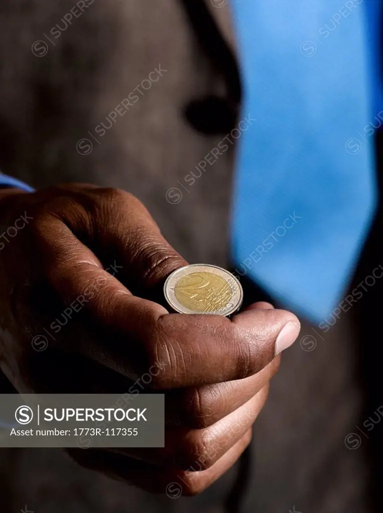 Business man ready to flip euro coin