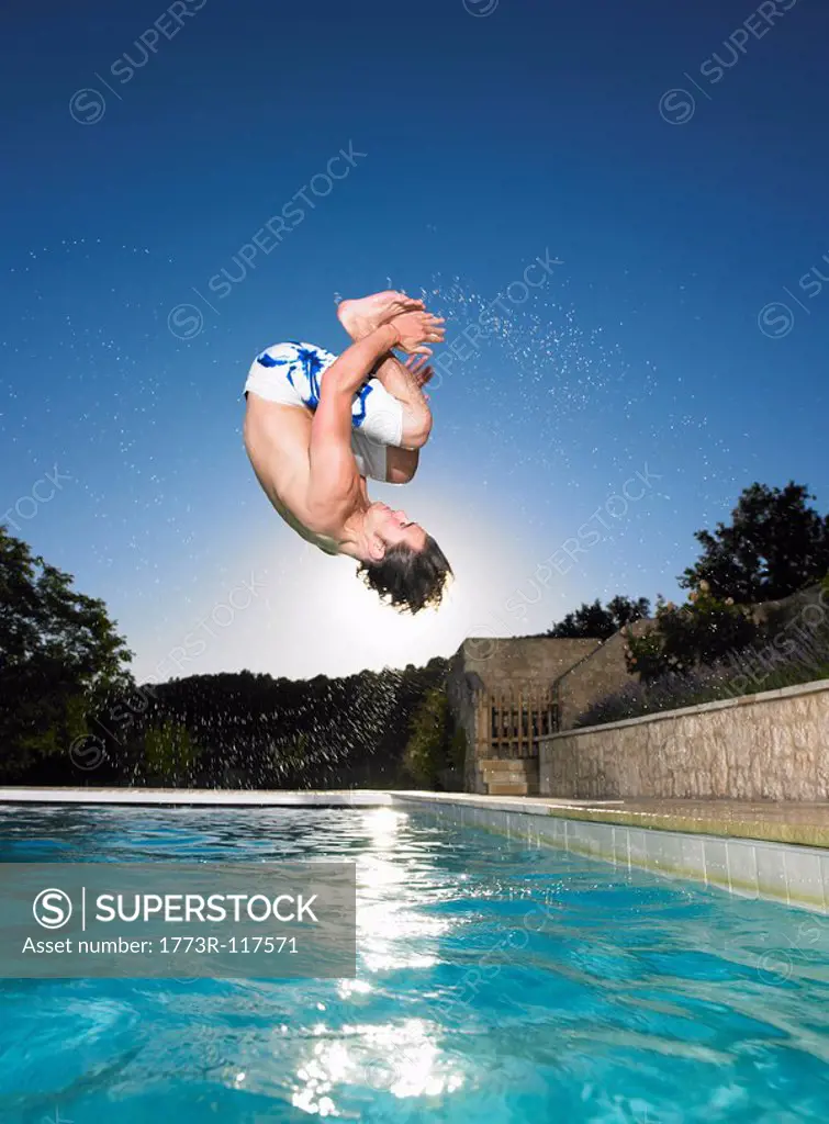man doing flip into pool