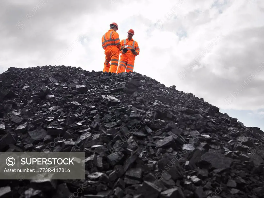 Coal Miners On Pile Of Coal