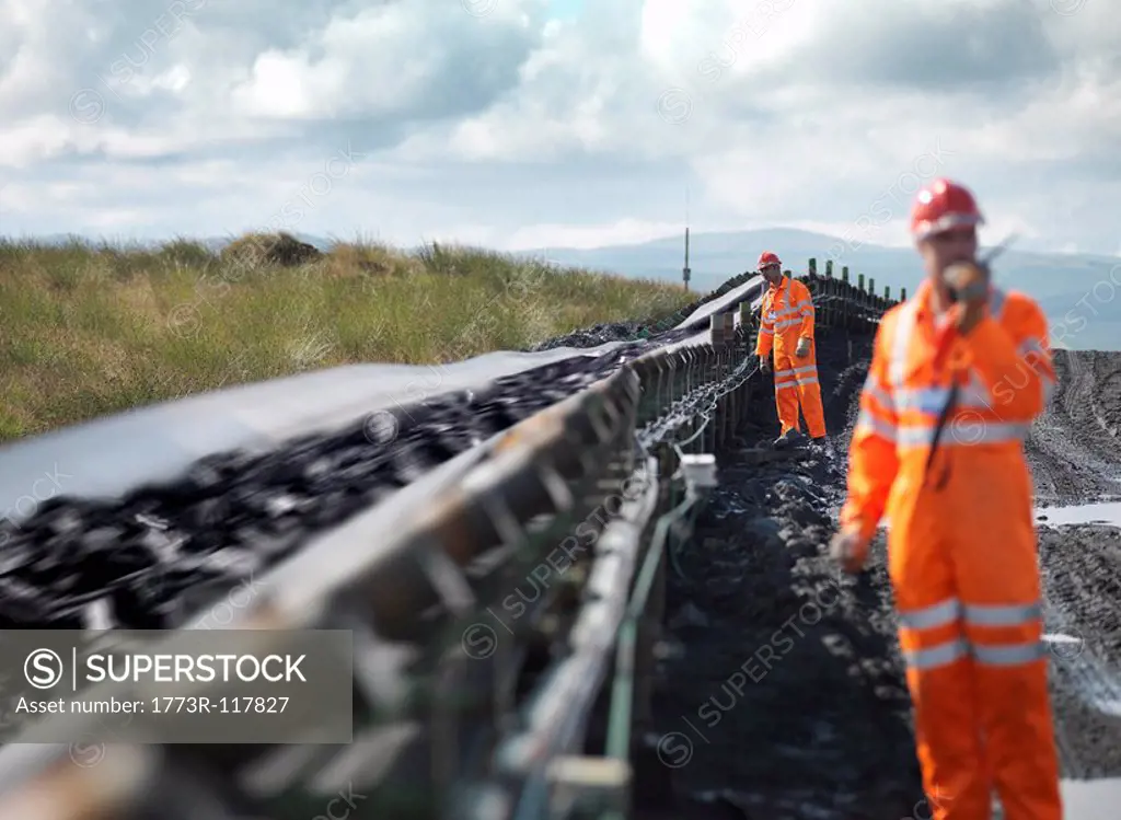 Coal Workers Inspecting Conveyor Belt