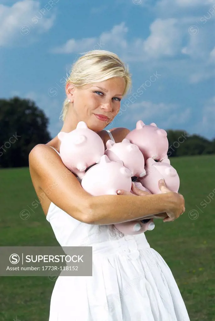 woman holding piggy banks