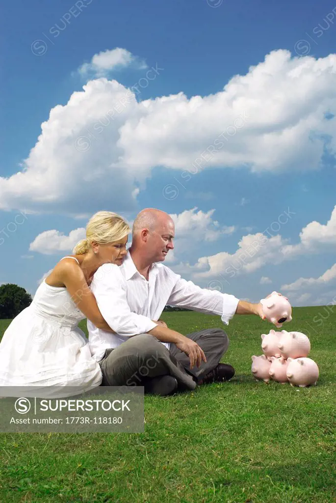 couple stacking piggy banks
