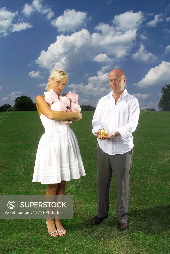 couple holding piggy banks
