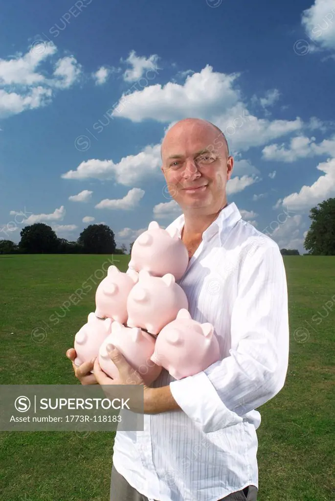 man holding piggy banks