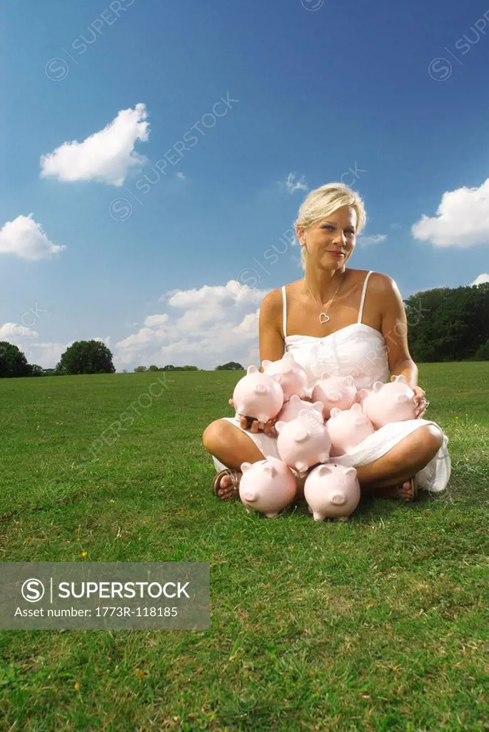 woman sitting with piggy banks