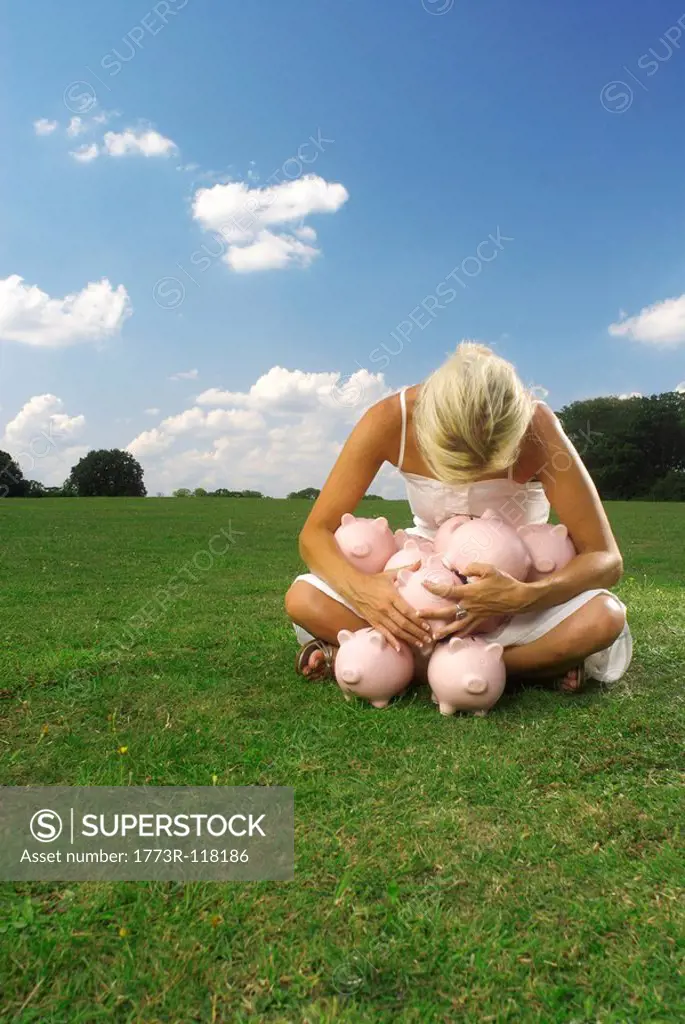 woman clutching piggy banks
