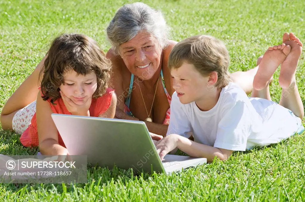 Senior female with children on laptop