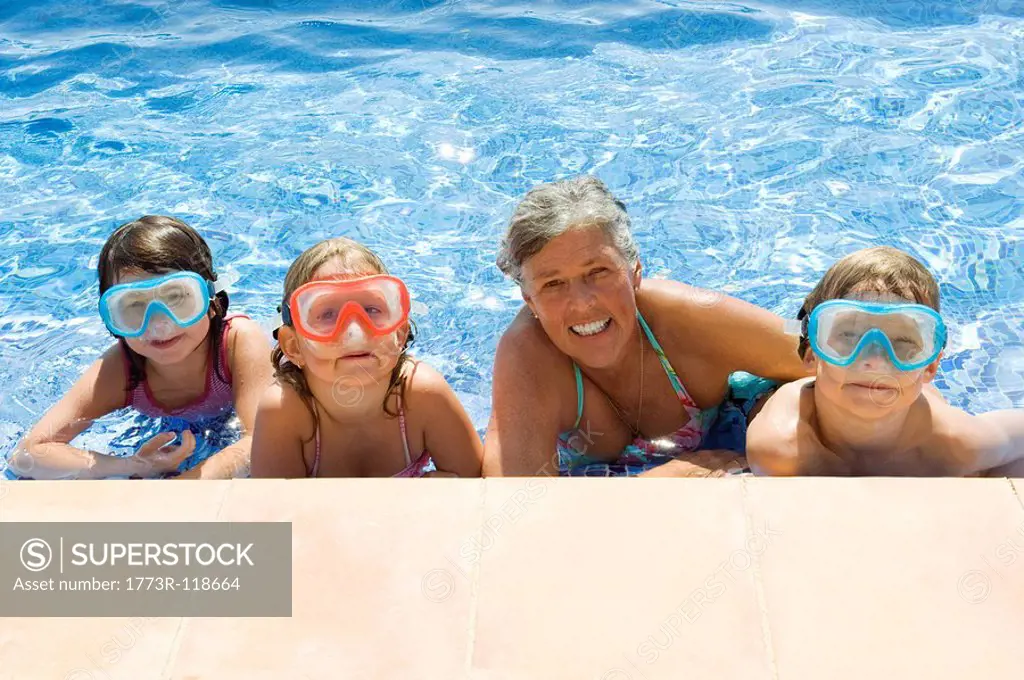 Children with a senior female in a pool