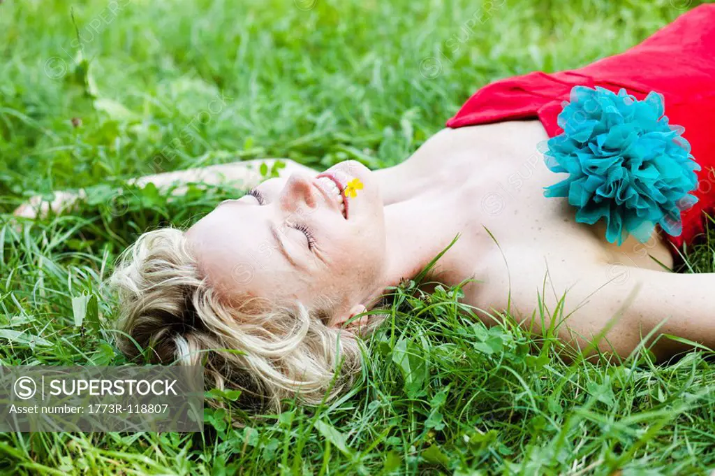 woman lying in grass eyes closed