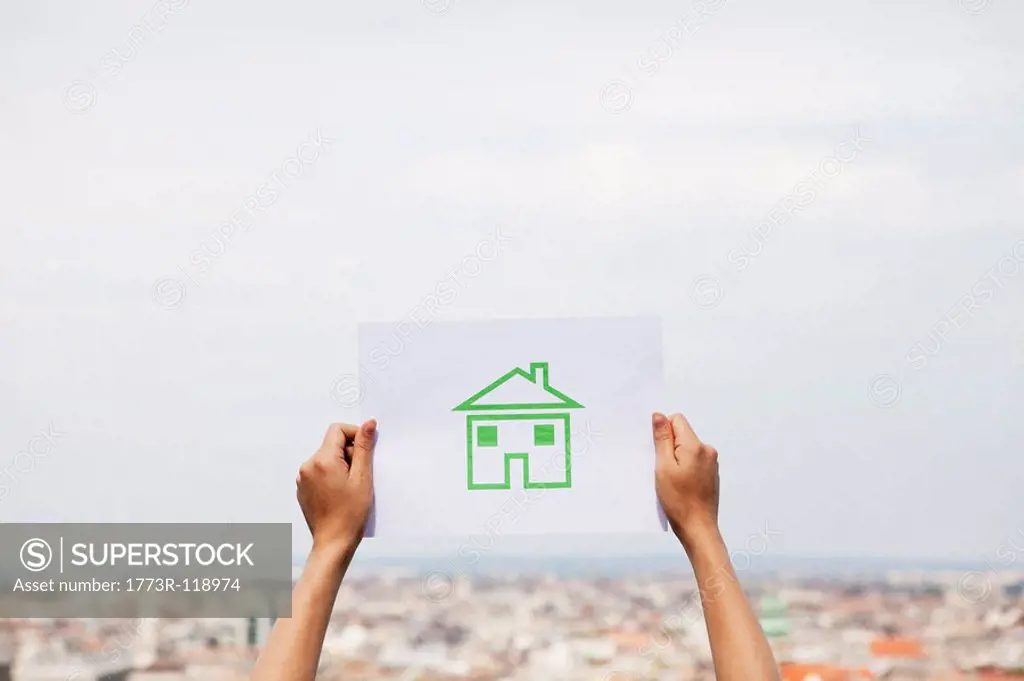 Arms holding paper green house