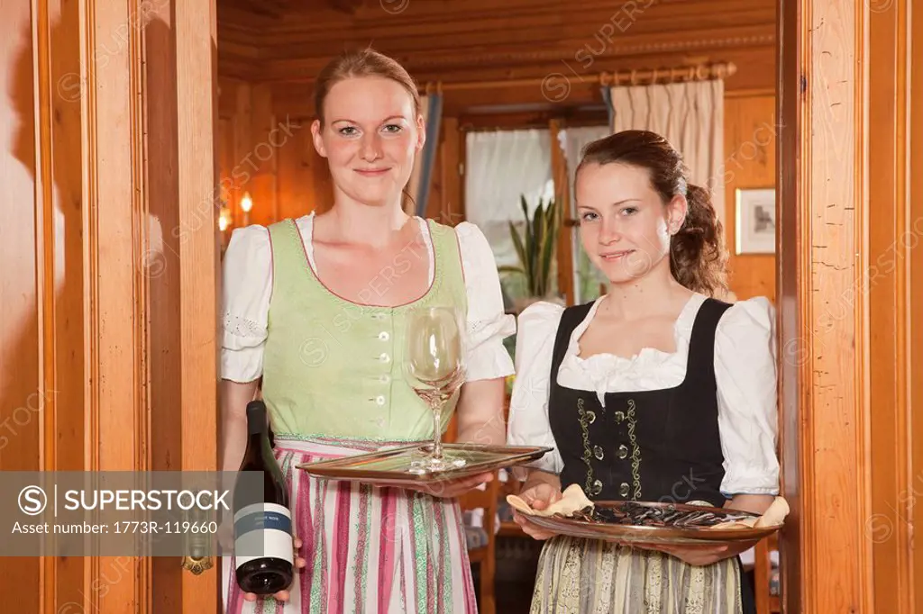 two waitresses with trays, smiling
