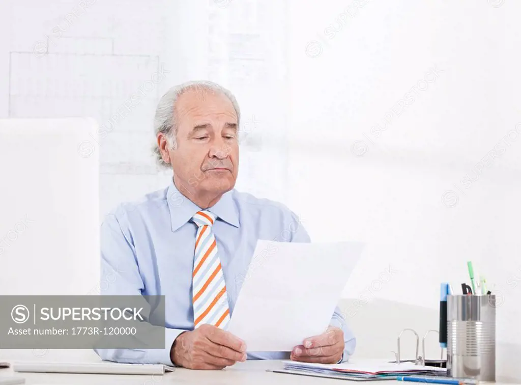 Man reading a paper in the office