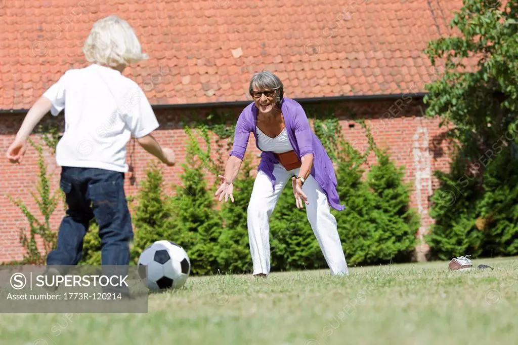 grandmother and child playing football