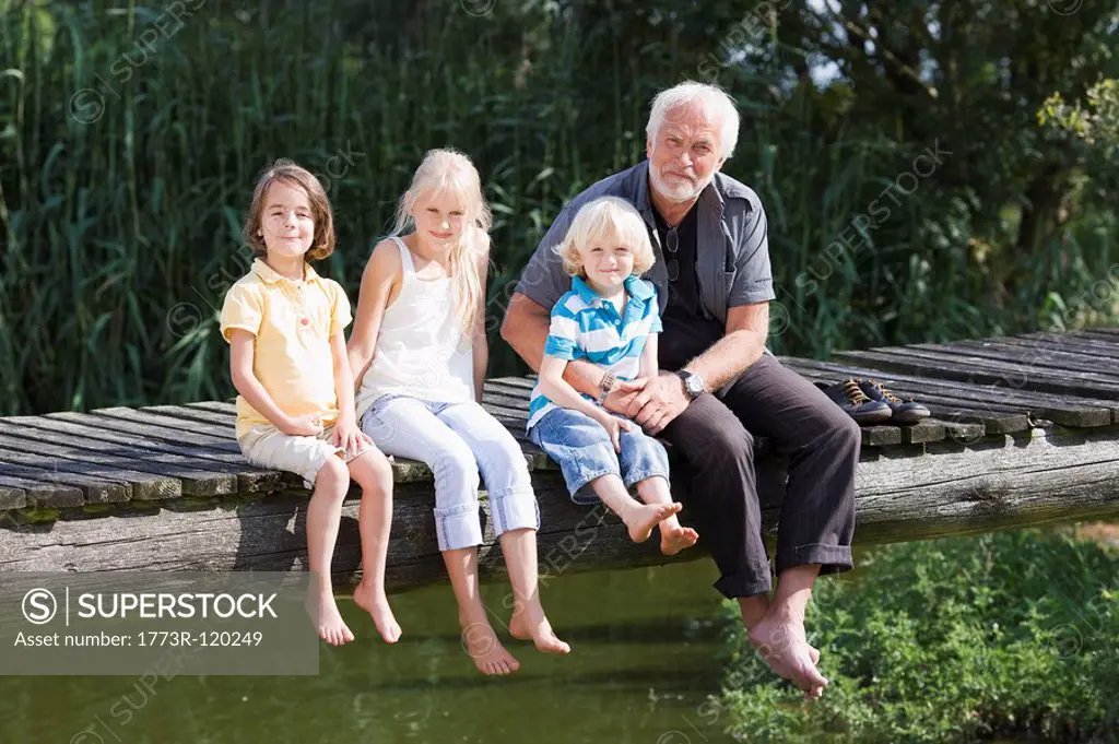grandfather and children on footbridge