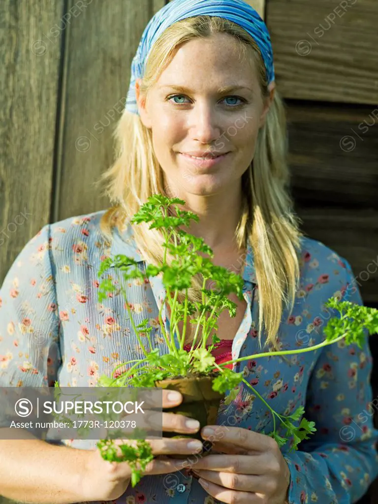 Young female with parsley plant