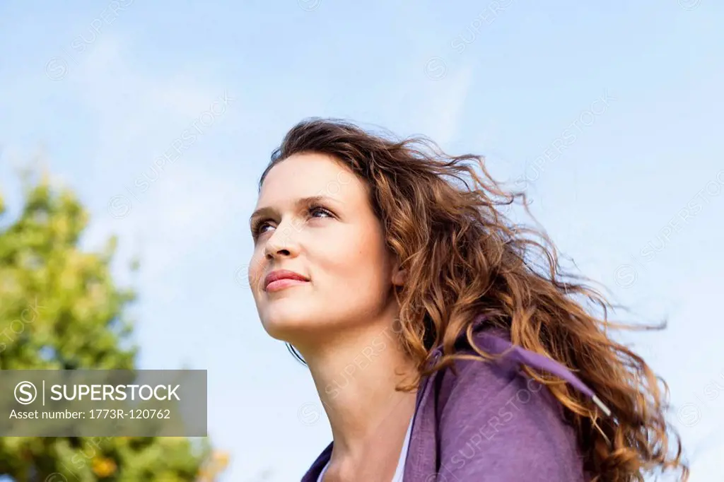 young woman looking in to sky