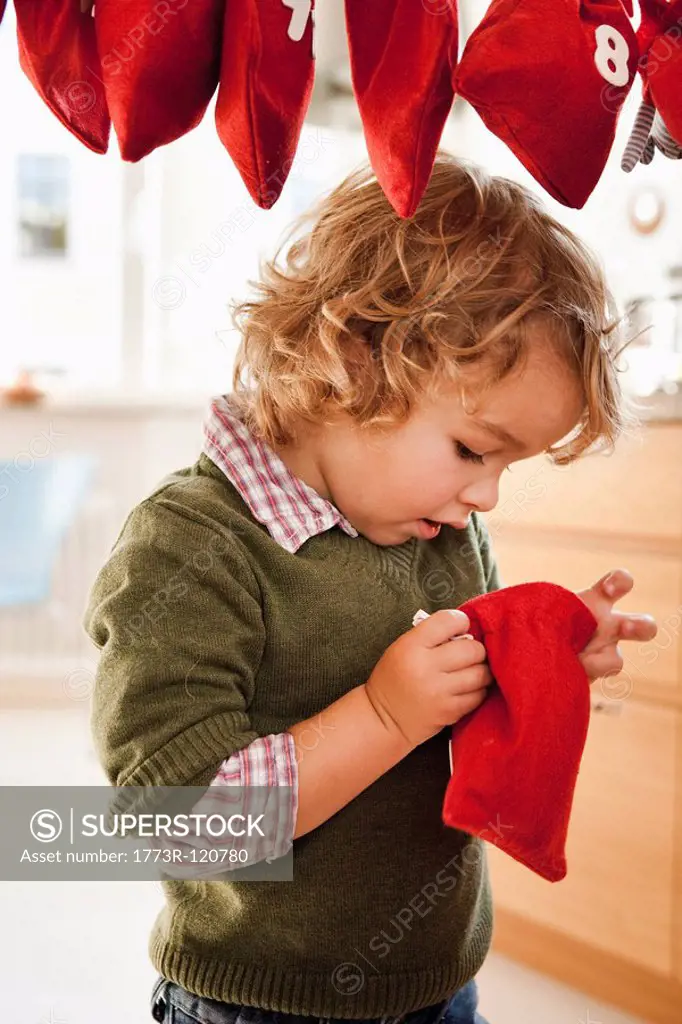 Young boy inspecting a christmas sack