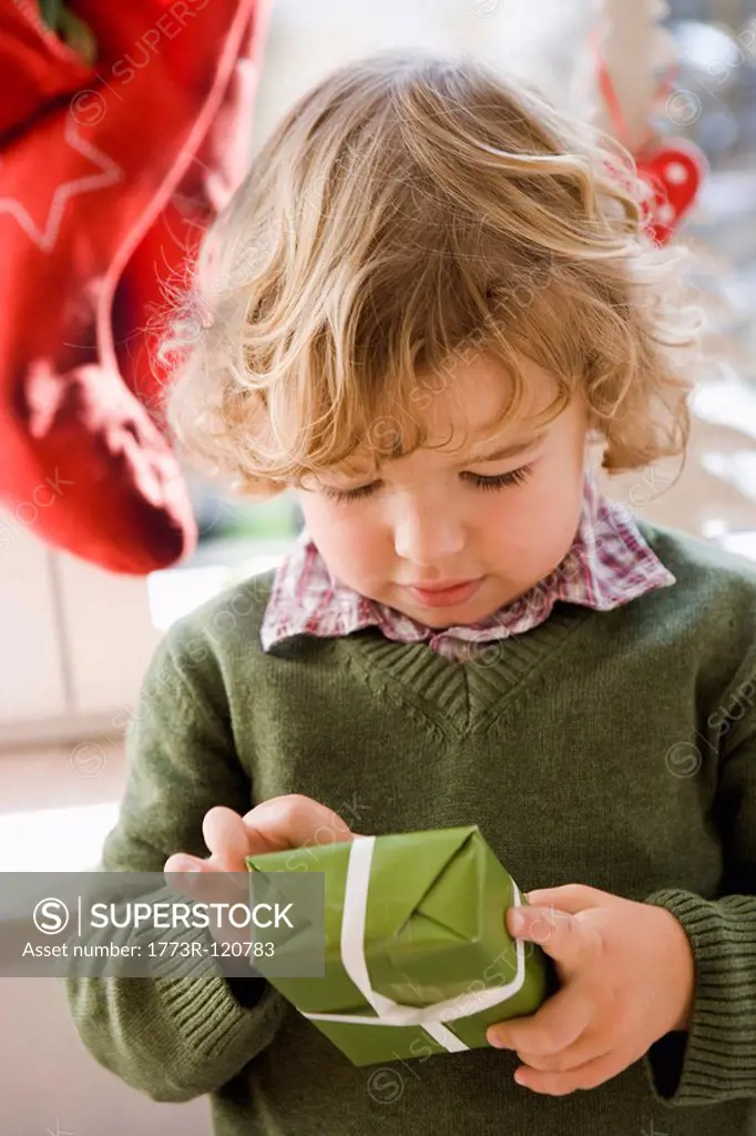 Young boy opening christmas present