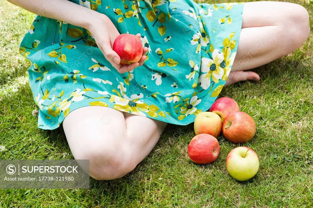 close up of girl holding apple.