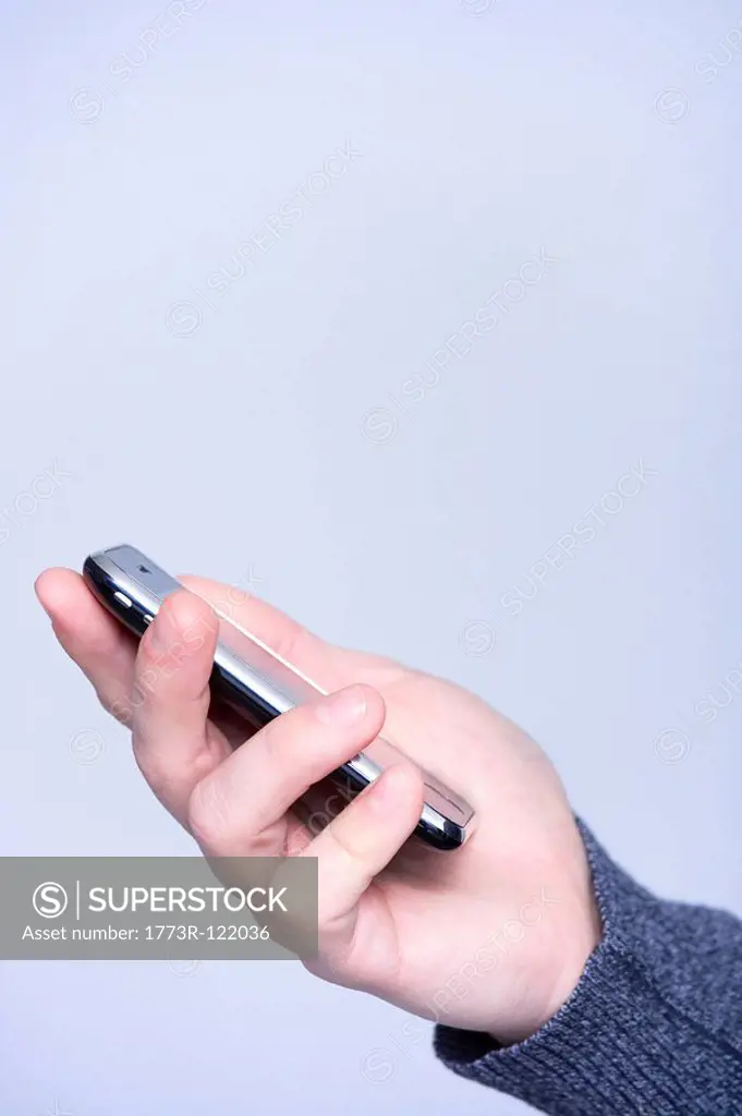 man s hand with a mobile phone