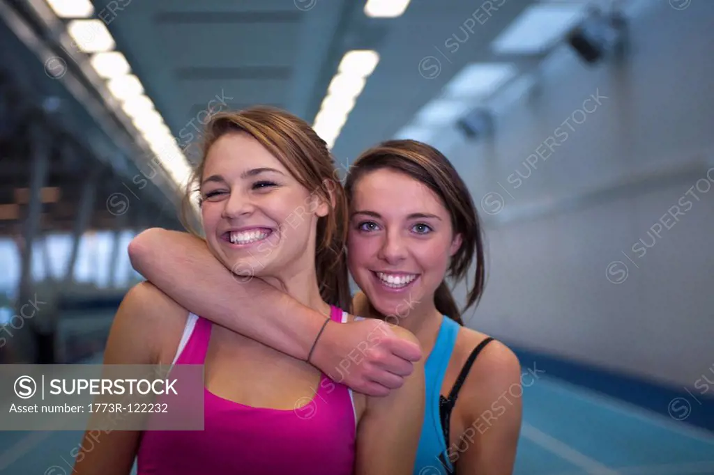 2 female athletes embracing