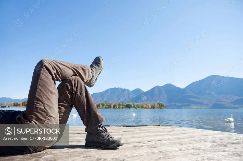 Man lying on a jetty