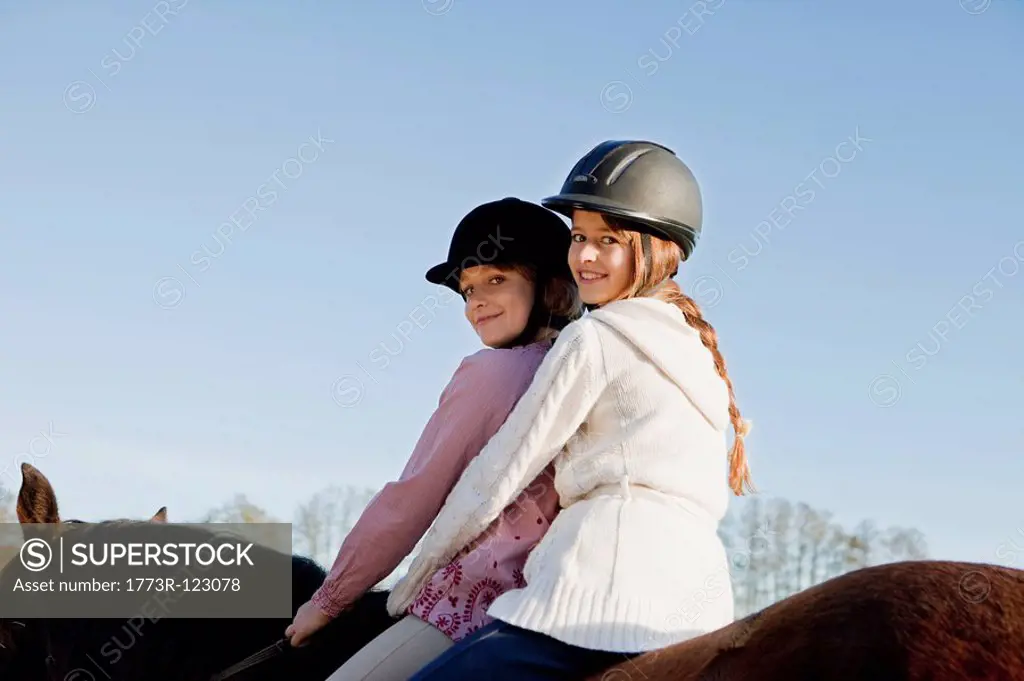 Two girls on a horseback