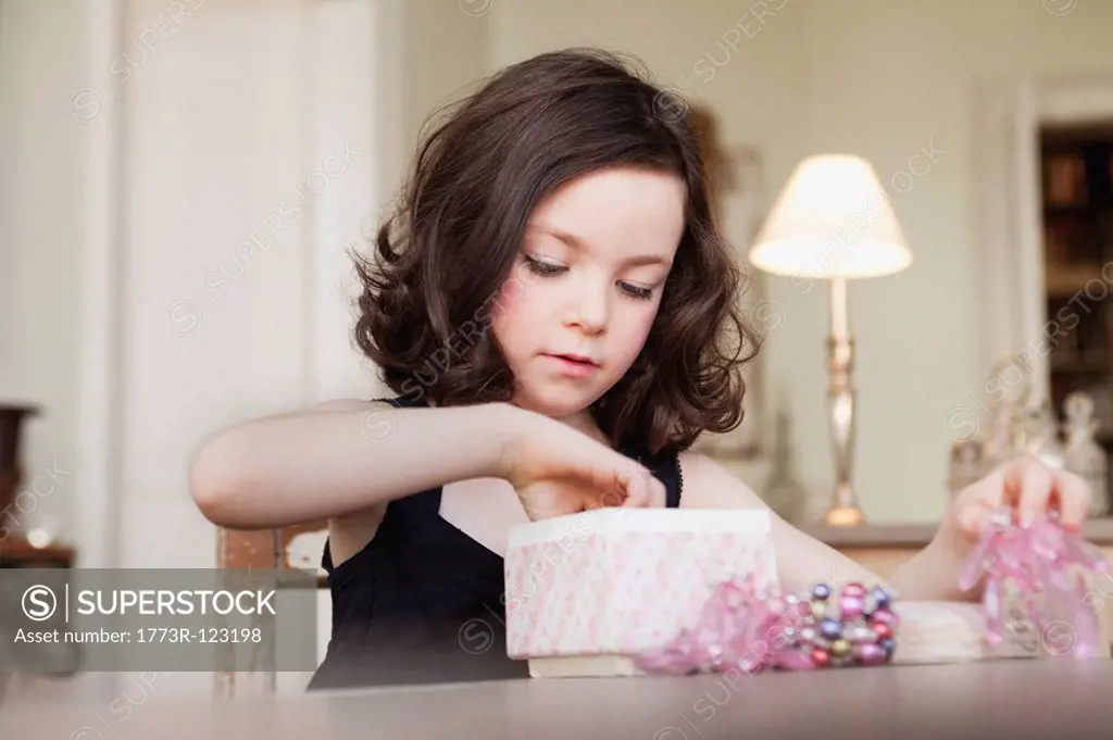girl exploring contents of parcel