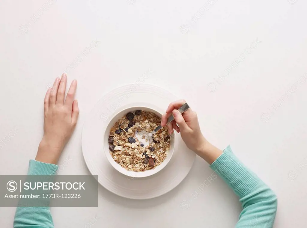 Hands by a bowl of cereal