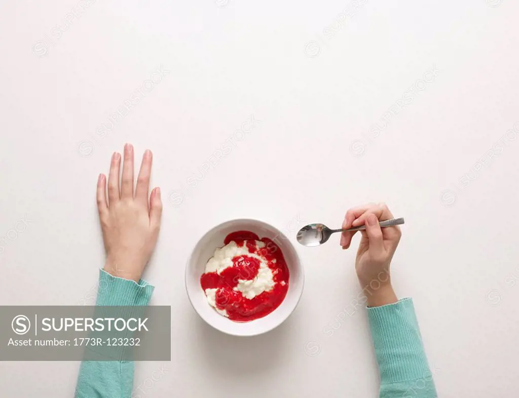 Hands by a bowl of desert
