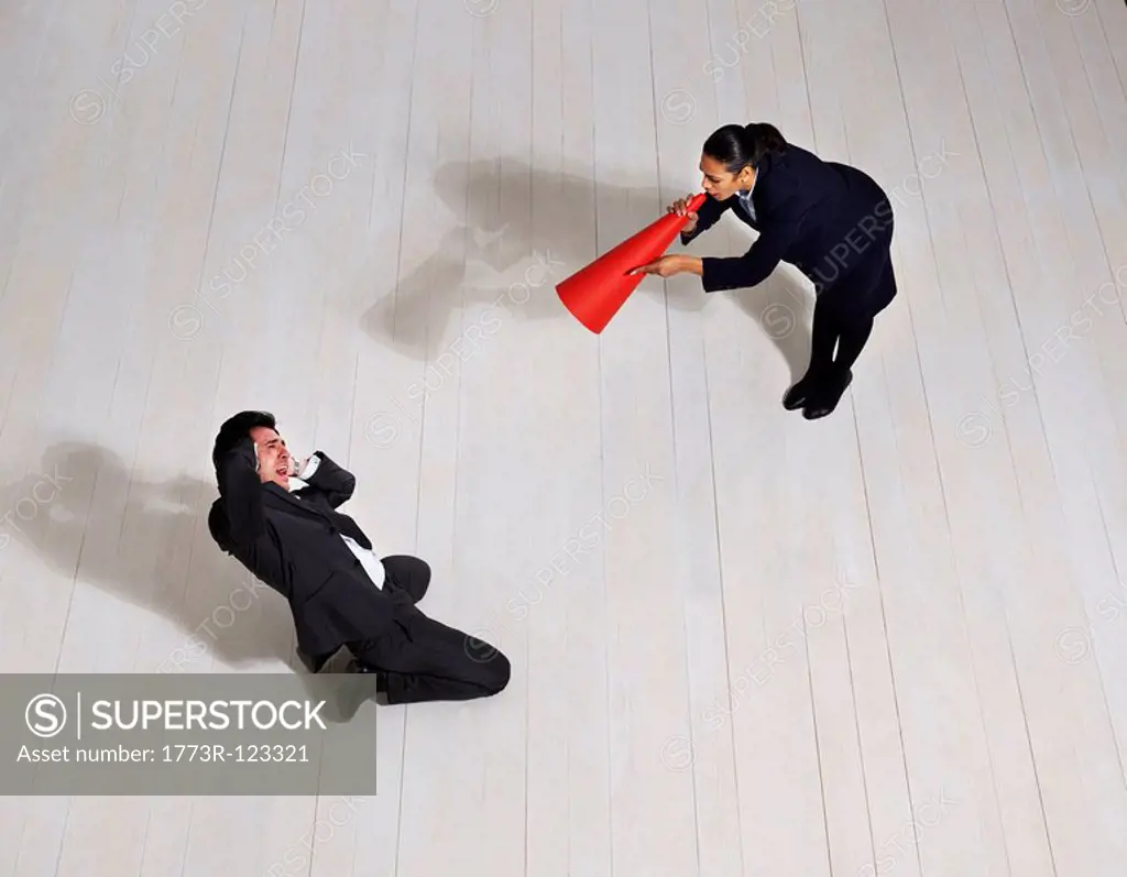 Business woman shouting at man on floor