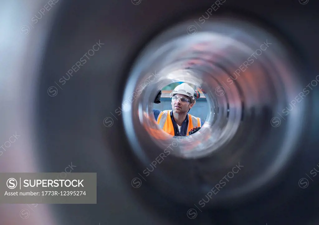 Engineer checking steel part in engineering factory