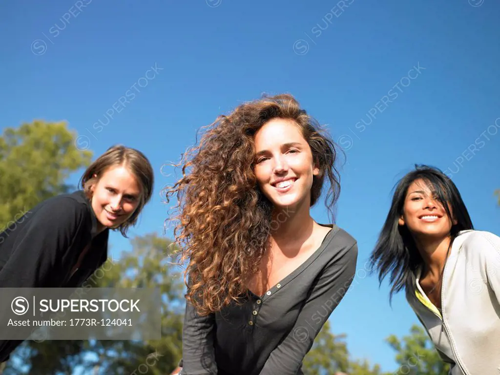 Women looking into the camera, smiling