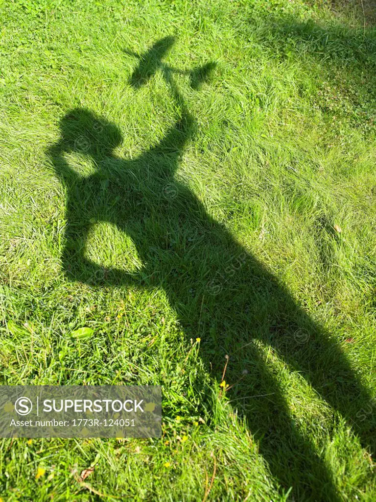 Shadow of a woman holding an rc plane