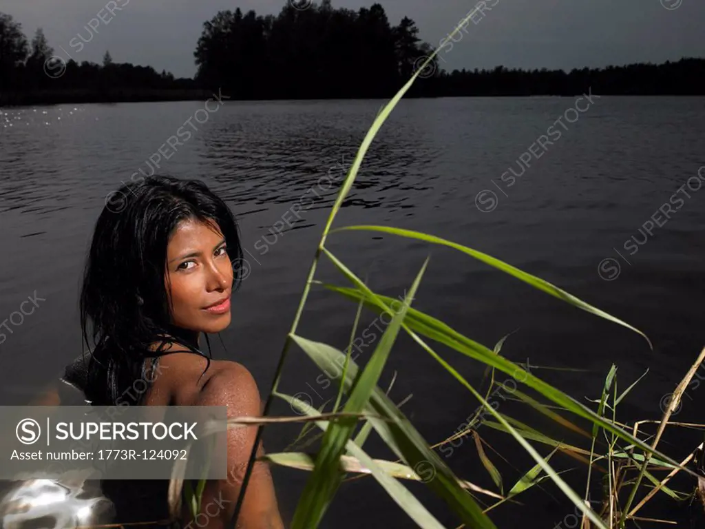 Woman in a lake at sunset